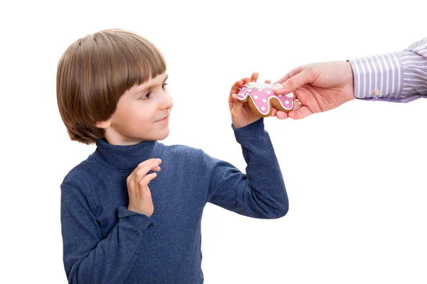 Happy boy gets gingerbread — Stock Photo, Image