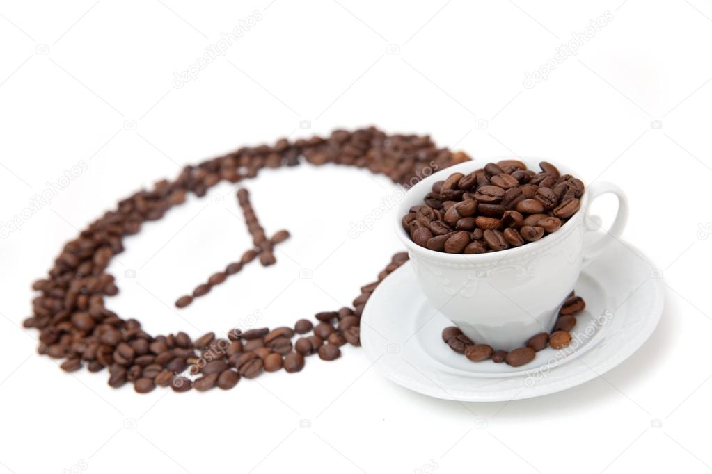 Cup of coffee bean in front of grain clock