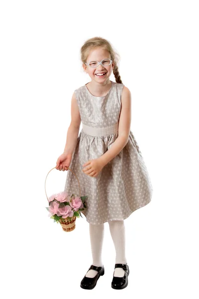 Cheerful girl with a basket of flowers — Stock Photo, Image