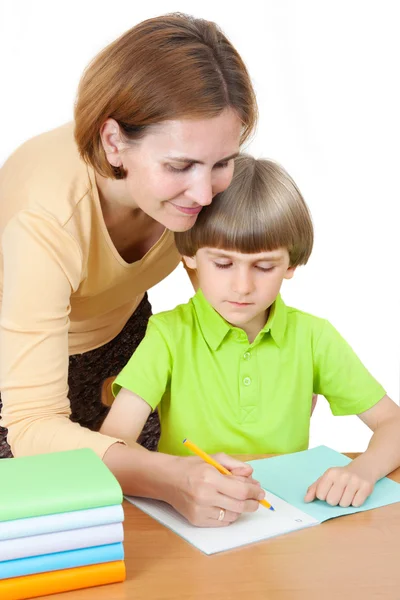 Woman helps first graders how to write — Stock Photo, Image