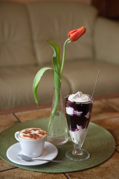 Cup of cappuccino and glass of curd — Stock Photo, Image