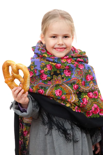 Girl in Russian kerchief with pretzel — Stock Photo, Image