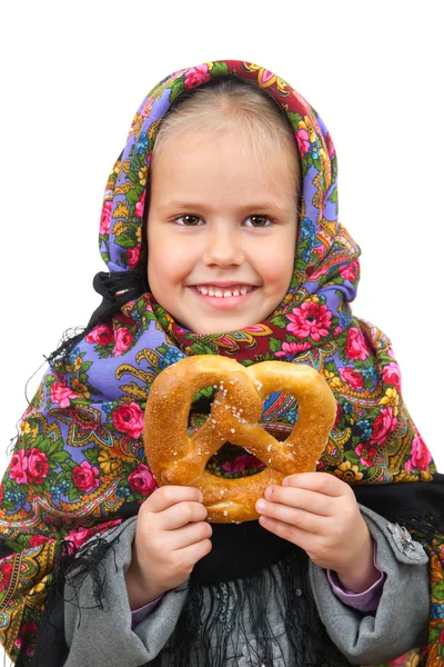 Girl in Russian kerchief with pretzel — Stock Photo, Image