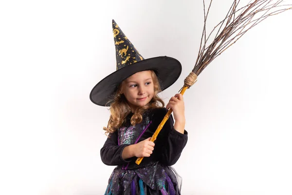 Little girl in halloween costume holding a pumpkin in her hands on a white background — Stock Photo, Image