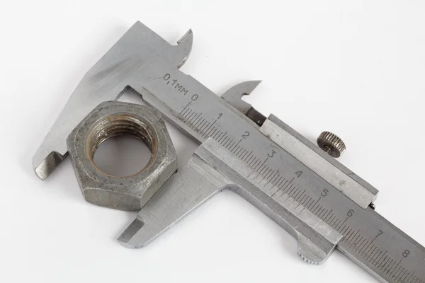 Measuring nut  with vernier caliper — Stock Photo, Image