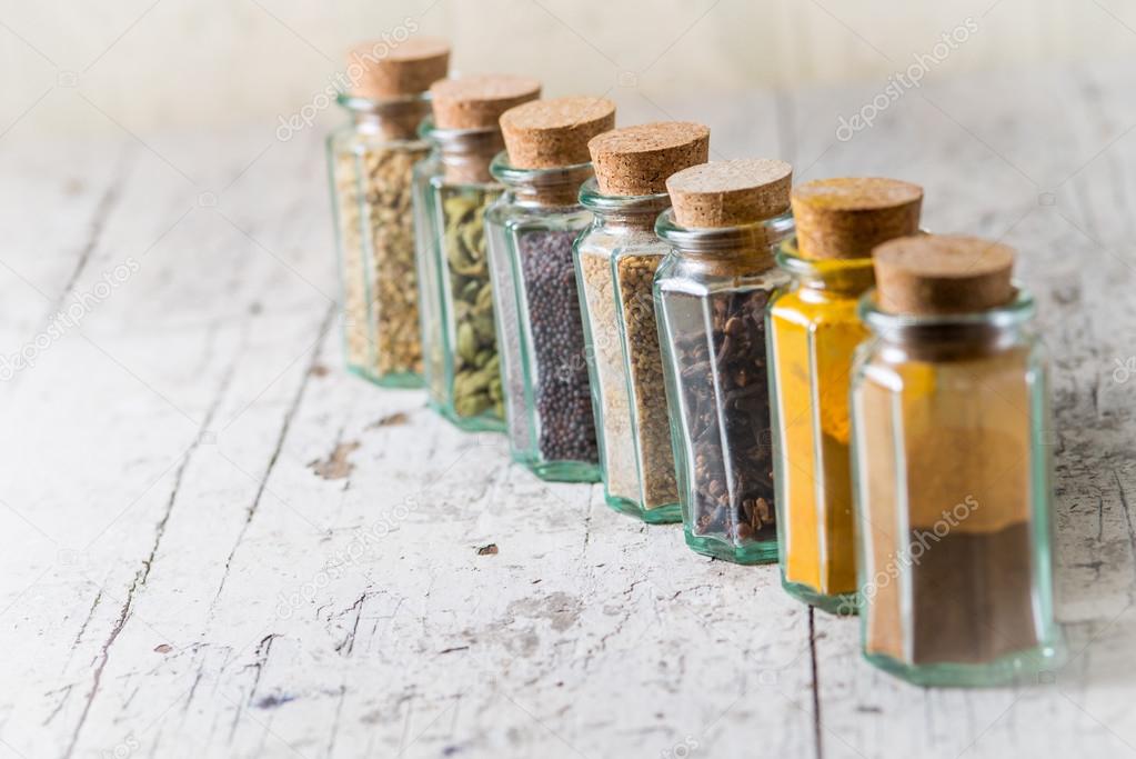Idian spices in a glass jars isolated