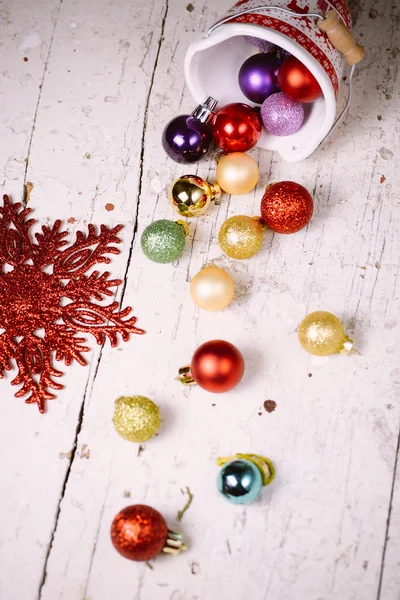 Porcelain bucket with colorful baubles for Christmas and New Yea — Stock Photo, Image