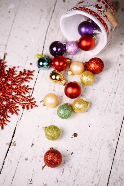 Porcelain bucket with colorful baubles for Christmas and New Yea — Stock Photo, Image