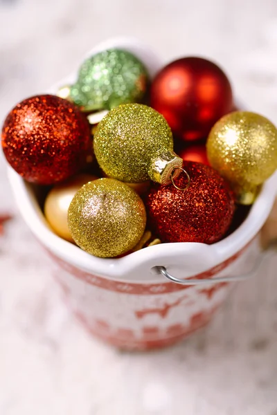 Porcelain bucket with colorful baubles for Christmas and New Yea — Stock Photo, Image