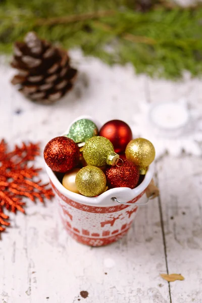 Porcelain bucket with colorful baubles for Christmas and New Yea — Stock Photo, Image