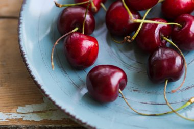 Ceramic plate of red juicy cherries