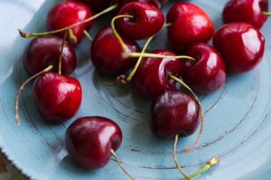Ceramic plate of red juicy cherries