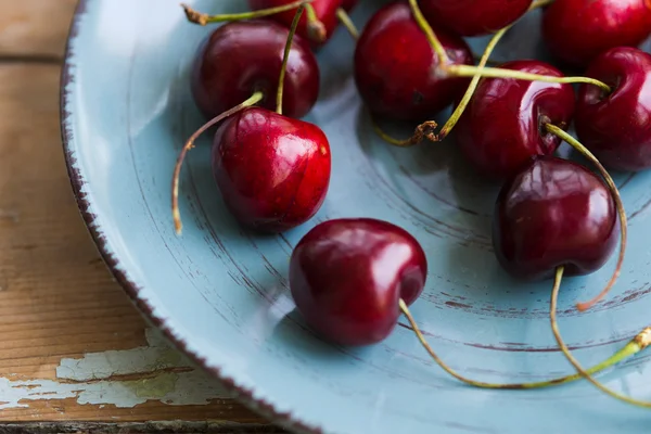 Ceramic plate of red juicy cherries — Stockfoto