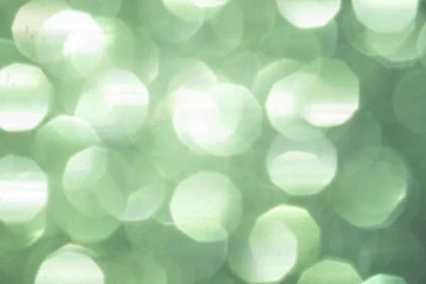Размытый праздничный изумрудно-зеленый блеск bokeh фон — стоковое фото