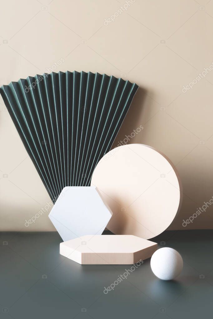Modern composition with beige and white shapes and emerald green paper fan on a color background