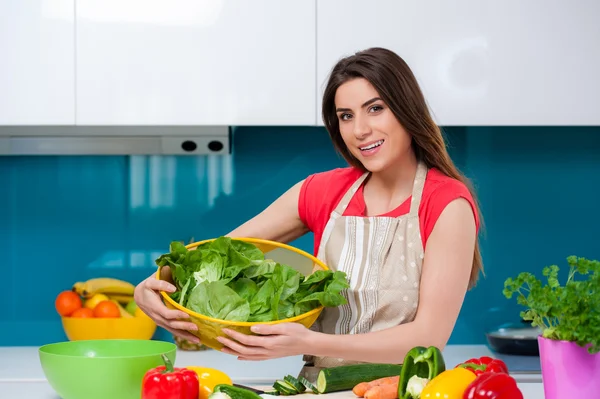 Holding a big bowl with fresh green salad Stock Picture