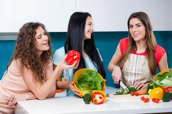 Friendship and healthy lifestyle cooking at home. Royalty Free Stock Photos