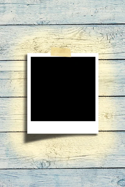 Blank polaroid photo frame on brown wood plank background — Stok fotoğraf