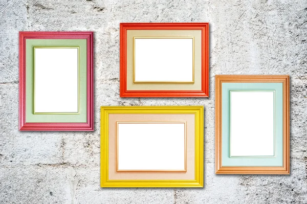 Four multicolored photo frames on the retro wall