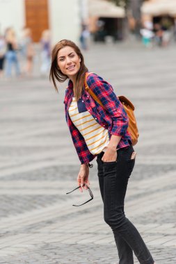 Young attractive woman traveling, visiting the medieval city.