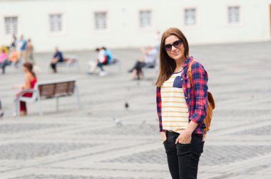 Young attractive woman traveling, visiting the medieval city.