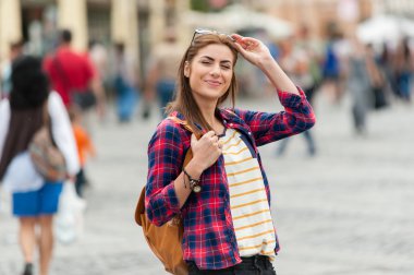 Young attractive woman traveling, visiting the medieval city.