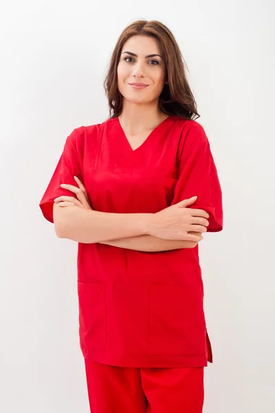 Portrait of happy young doctor woman standing isolated over white background — ストック写真