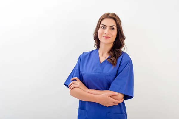 Portrait of happy young doctor woman standing isolated over white background — ストック写真