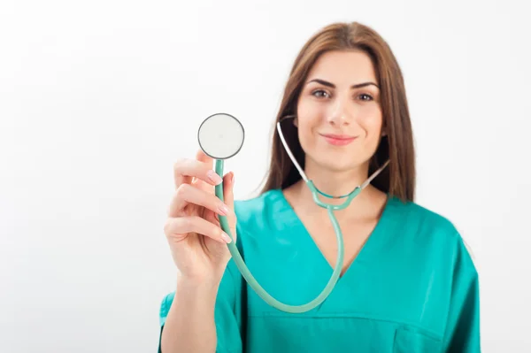 Woman in medical doctor uniform holding stethoscope — Zdjęcie stockowe