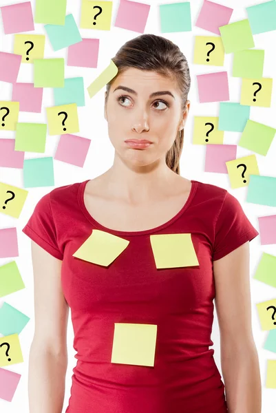 Busy woman against wall covered with colorful stickers — Stock Photo, Image