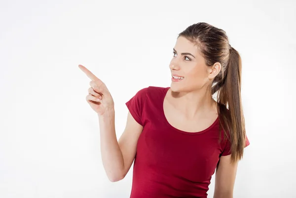 Isolated young woman is presenting or pointing with her finger. — Stock Photo, Image