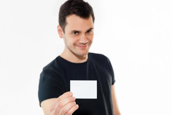 Young man holding blank white card — Stock Photo, Image