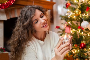 Woman holding a small candel
