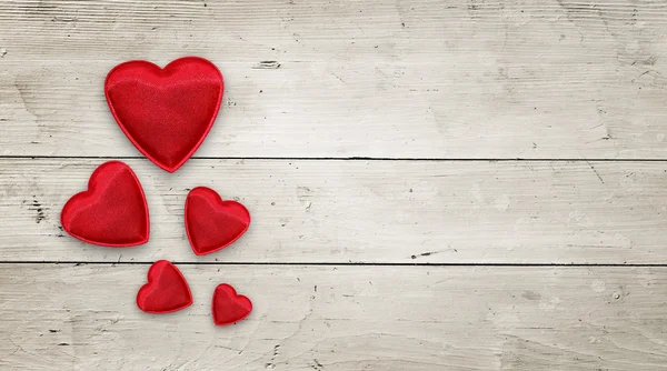 Red hearts on wood — Stock Photo, Image