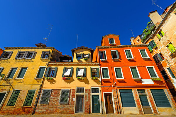 Venice, colorful houses, summer sunny day, blue sky,linear perspective