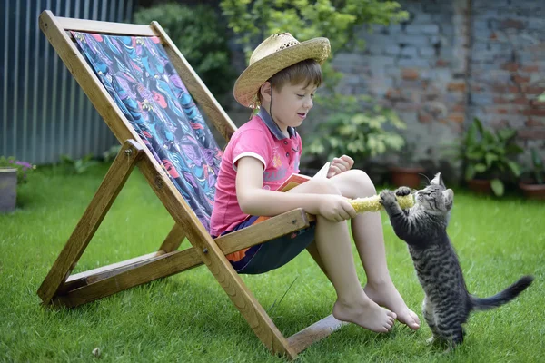 Junge spielt mit Katze lizenzfreie Stockfotos