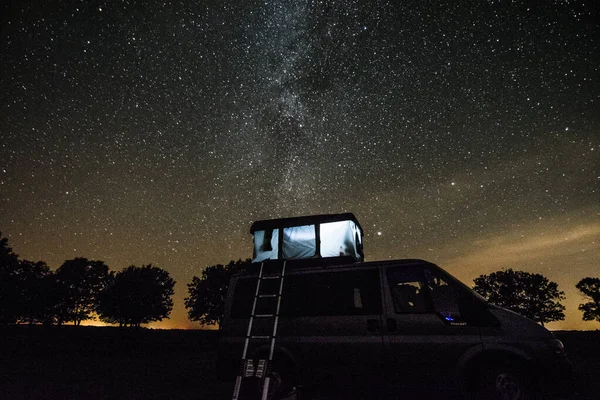 Gece vakti Bebrza Ulusal Parkı 'nda kamp minibüsü vith Çadırı..