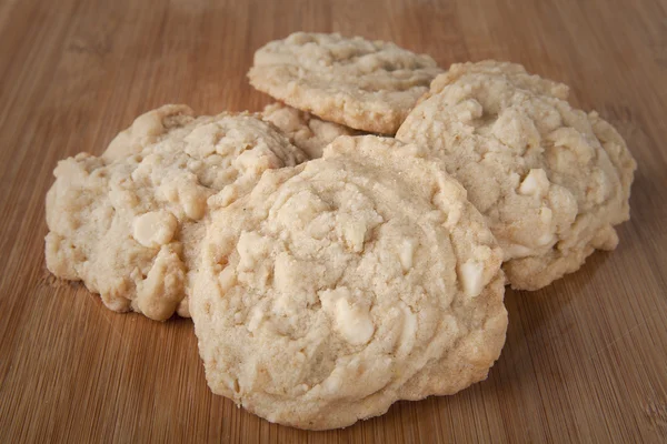 Stack of macadamia nut cookies on cutting board — Stock Photo, Image