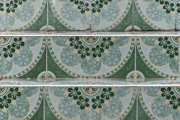 Stairs are paved with flower-patterned tiles.