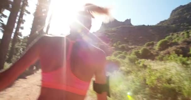 Athletic woman walking away on a mountain nature trail — Stock Video