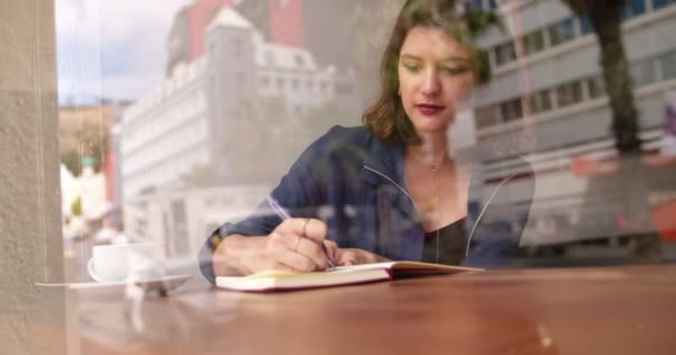 Woman Writing Journal in Coffee Shop — Stock Video