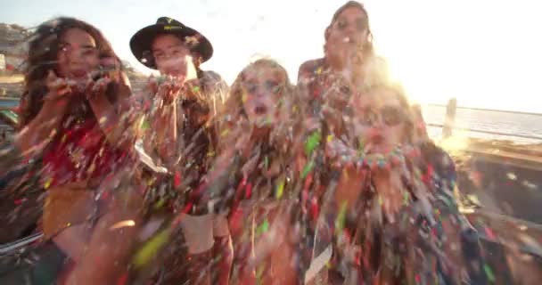 Friends celebrating by blowing confetti from hands — 비디오