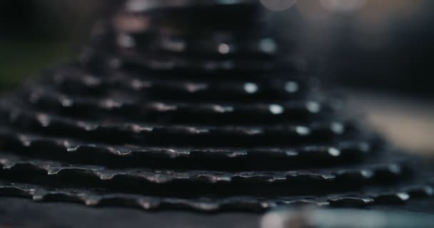 Bicycle gears stacked on each other on a workbench — Stock Video