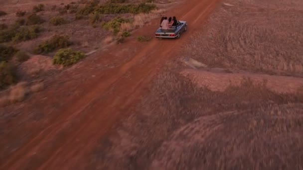 Friends carefree in vintage convertible car during road trip — Stock Video