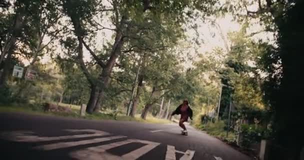 Girl riding her longboard along a road — Stock Video