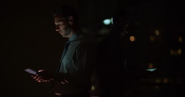 Businessman using digital tablet on balcony — Stock Video