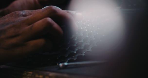 Hands of craftsperson assembling bicycle gears at a work bench — Stock Video