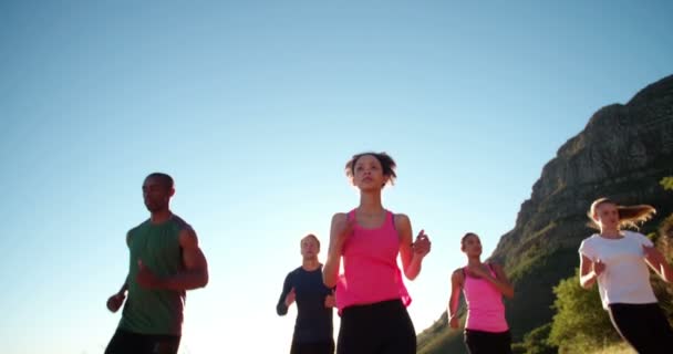 Teen athletes jogging outdoors — Stock Video