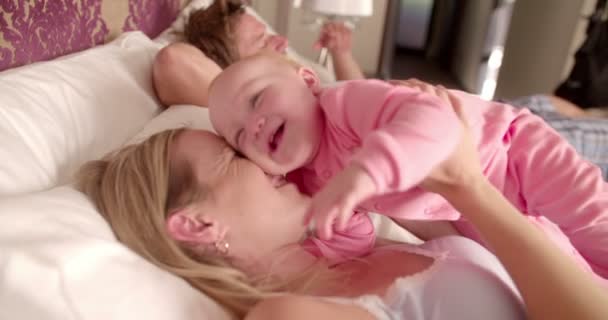 Familia jugando juntos en la cama en casa — Vídeo de stock