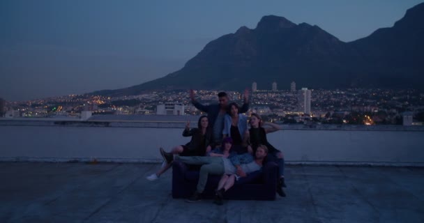 Friends hanging out on the rooftop for a party — Stock Video